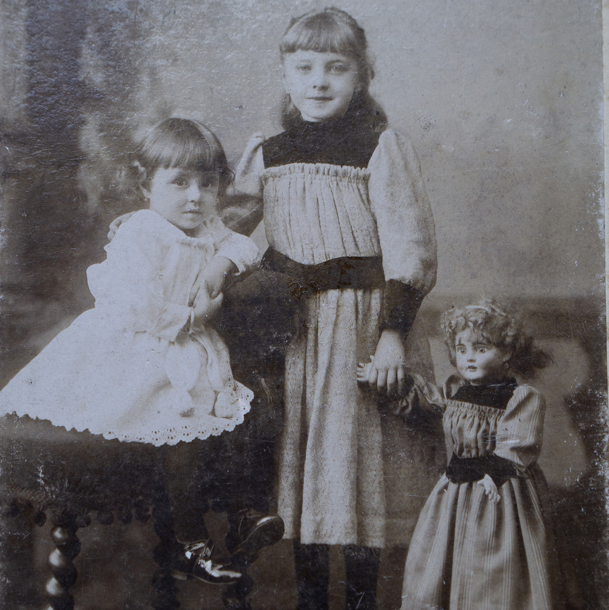 Two girls with their doll, c.1884